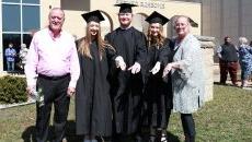 3 siblings and their mom pose with a Ring